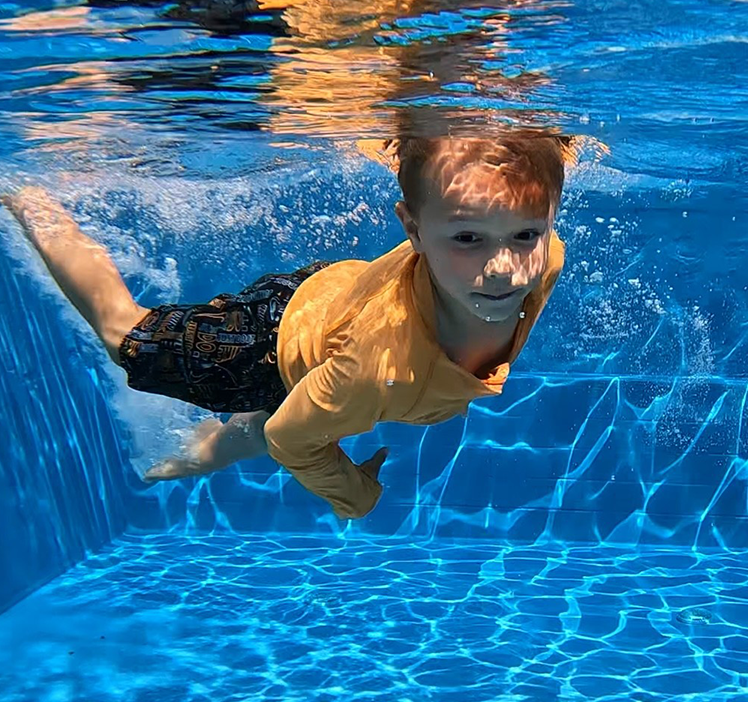Student practicing their stroke underwater